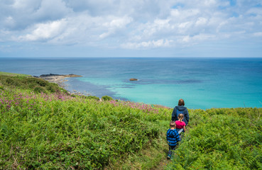 Fototapeta na wymiar Family walking on the Cornish coast