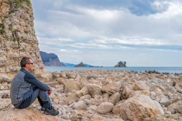 Man resting on the rocky coast