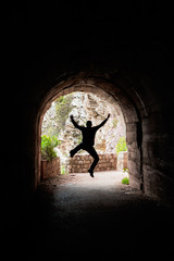 Man jumping in a dark tunnel