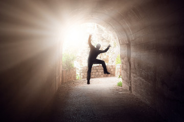 Obraz na płótnie Canvas Man jumping in a dark tunnel