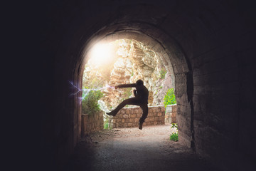Man practicing karate moves in a tunnel