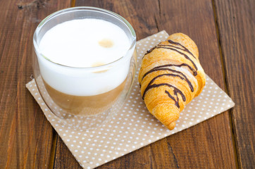 Cappuccino in glass cup with croissant for lunch. 