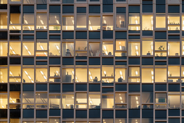 Closeup view of glowing windows of skyscraper. Office building