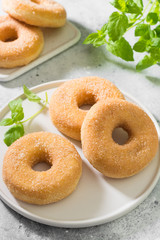 Doughnuts with sugar sprinkles. Light grey background