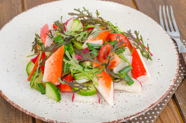 Fresh vegetable salad with crab sticks. 