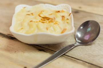 Au Gratin in white bowl on a wooden table