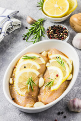 Lemon rosemary garlic chicken, marinated, ready for baking. Selective focus, space for text.