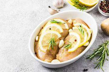 Lemon rosemary garlic chicken, marinated, ready for baking. Selective focus, space for text.