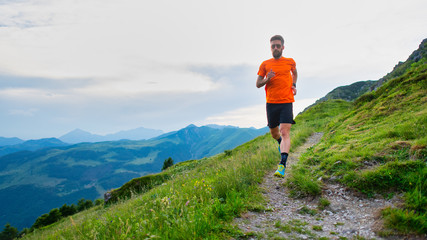 Trail running athlete during a training on mountain trail