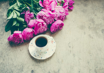 cup of coffee with flowers on wooden background