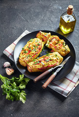 Stuffed zucchini with tomato slices and cheese