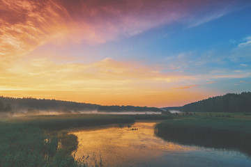 The magical sunrise over the lake. Rural landscape