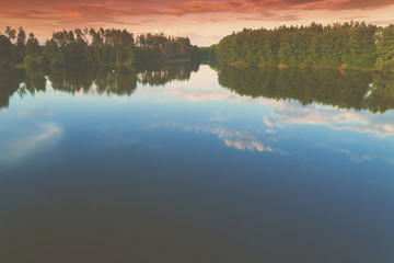 The magical sunrise over the lake. Rural landscape