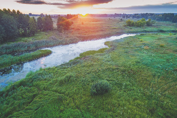 Magical sunset over the countryside. Rural landscape in the evening. Aerial view