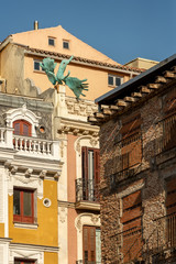 Obraz premium Madrid, Spain. Air accident. The sculpture of angel on the roof of the house, the sculptor Miguel Angel Ruiz. Bronze figure adorns the fasade of a building on Calle Milaneses, near to the Plaza Mayor.