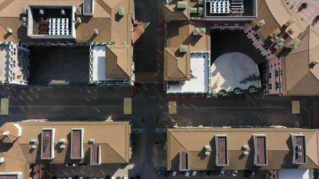 Aerial video shooting. House roof. View down. Residential area. Place to live. City planning. No people. The Windows of the houses.