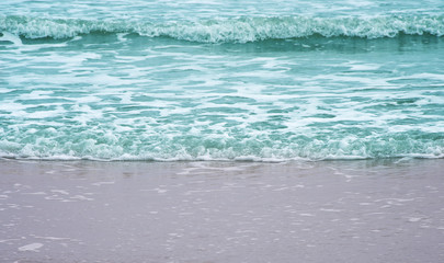 Colorful light blue wave on sandy shore nature sea background