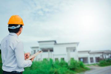 Male engineer inspection checking on container background With note on notepad or...