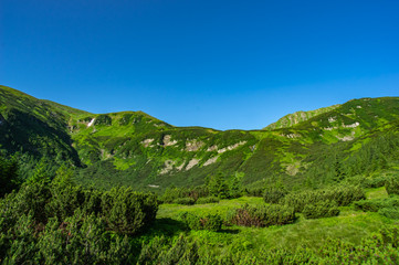 Green hills against the blue sky in the mountains