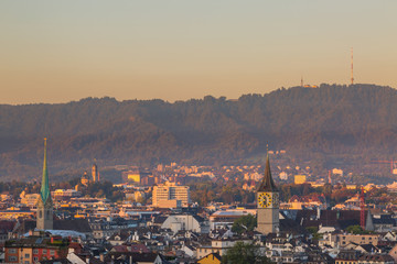 Fototapeta na wymiar view on churches, roofs and Uetliberg of Zurich city