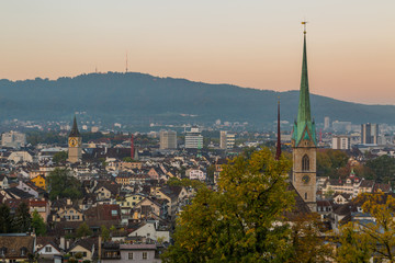 Fototapeta premium view on churches and roofs of Zurich city in the morning
