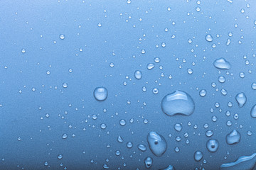 Drops of water on a color background. Selective focus. Blue. Toned