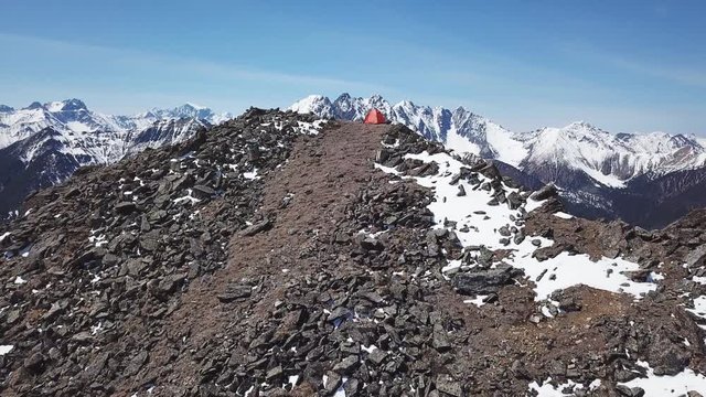 Drone shot orbiting a shelter tent on top of the mountain. Baikal, Siberia