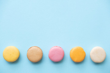 Top view of colorful macaron or macaroon on blue   background. .Space for your text