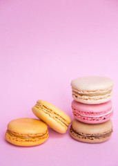 Tasty sweet macarons. Macaroons on pink background. Place for text
