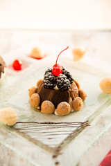 Christmas Tiramisu with biscuits, blackberries and cherry on top