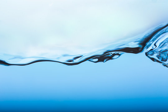 Water splash, clear blue water with waves and bubbless