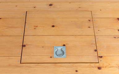 Wooden square old hatchway in the cellar