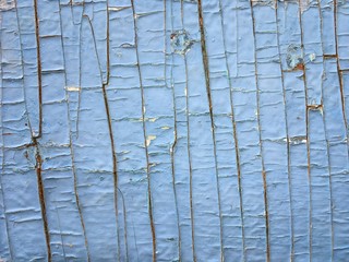 old wooden surface with cracked blue paint