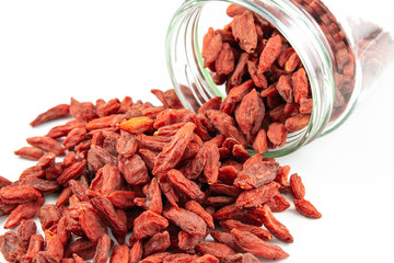 dried goji berries spilling out of glass jar