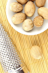 nutmeg seeds in a small white bowl