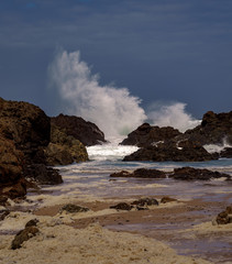 waves crashing on the rock, spray