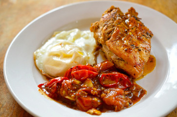 Close up of Fried chicken fillet with garnish of tomato