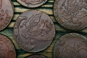 Numismatics. Old collectible coins made of copper on a old wooden table.