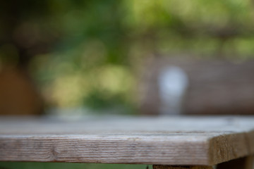 wooden table against a blurred green garden