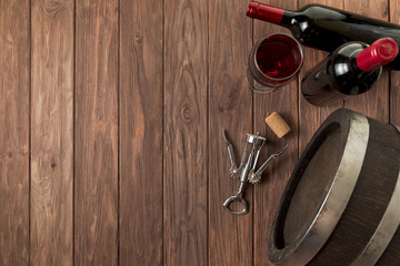 Fototapeta premium Top view wine bottles on wooden background