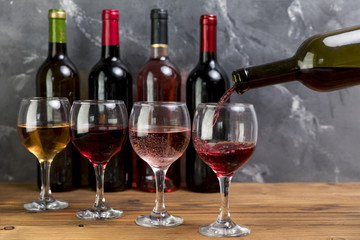 A wine bottle filling wineglass