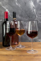 Line of wine bottles and wineglasses