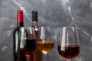 Line of wine bottles and wineglasses