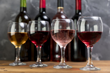 Line of wine bottles and wineglasses
