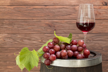 Bunch of grapes on wooden barrel