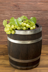 Bunch of grapes on wooden barrel