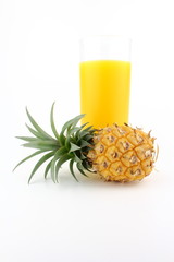 fresh pineapple and a glass of pineapple juice isolated on a white background with copy space