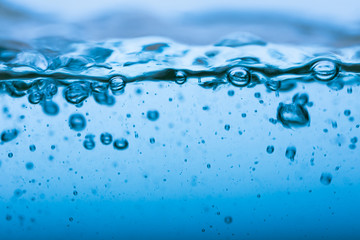 Water splash, clear blue water with waves and bubbless