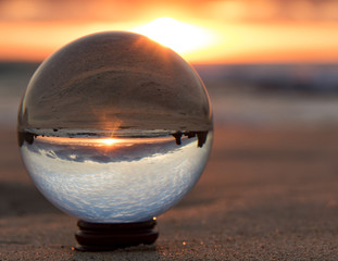 lensball on the beach at sunrise