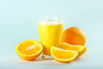 Glass with fresh orange juice with fruits, isolated.